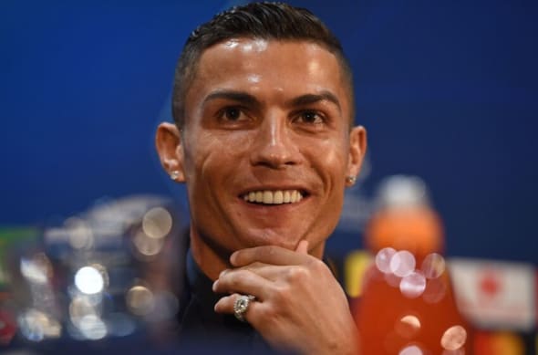 Portuguese striker Cristiano Ronaldo smiles during a press conference at Old Trafford in Manchester, northwest England. Should PSG make an effort to sign the Manchester United legend? (Photo credit should read OLI SCARFF/AFP via Getty Images)