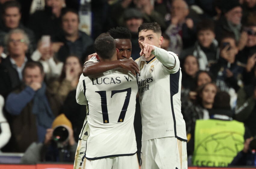 Real Madrid's Brazilian forward #07 Vinicius Junior celebrates with Real Madrid's Uruguayan midfielder #15 Federico Valverde and Real Madrid's Spanish forward #17 Lucas Vazquez scoring his team's second goal during the UEFA Champions League group C football match between Real Madrid CF and SC Braga at the Santiago Bernabeu stadium in Madrid on November 8, 2023. (Photo by Thomas COEX / AFP) (Photo by THOMAS COEX/AFP via Getty Images)