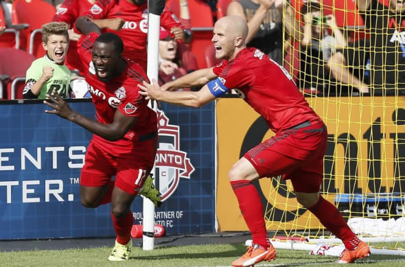 Sep 26, 2015; Toronto, Ontario, CAN; Toronto FC midfielder Michael Bradley (4) reacts to the winning goal against the Chicago Fire by Toronto FC forward Jozy Altidore (left) at BMO Field. Toronto defeated Chicago 3-2. Mandatory Credit: John E. Sokolowski-USA TODAY Sports